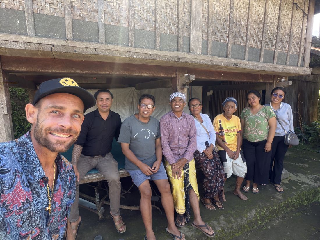 Kai with the guardian family, seated outside their family house in Munduk.